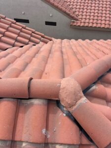 IMG_2338 - Desert Sands Contracting Clay roof tiles with a patched joint where plaster covers a roof seam, likely a repair on a terracotta roof.