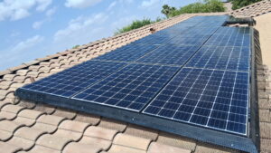 solar services by desert sands - Desert Sands Contracting Solar panels installed on a sloped terracotta tile roof under a blue sky.